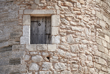 Wooden window in a medieval stone tower.