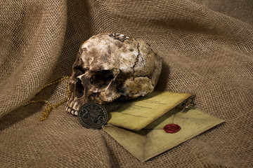 Damaged skull with a letter, with a burlap background