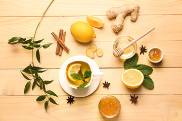 Cup of hot tea with lemon, ginger and honey on wooden table