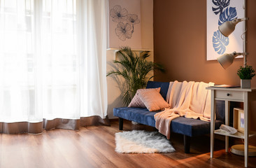 Interior of living room with stylish blue sofa