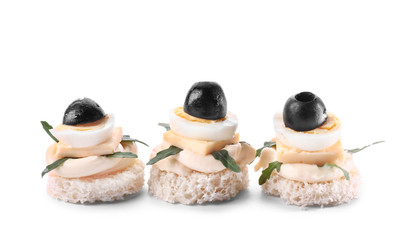 Tasty canapes on white background