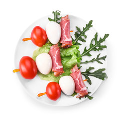Plate with tasty canapes on white background