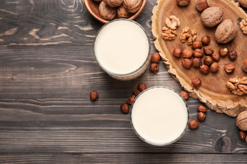 Obraz na płótnie Canvas Tasty nut milk on wooden table