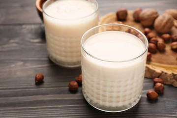Tasty nut milk on wooden table