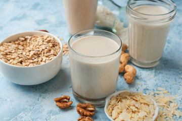 Assortment of tasty vegan milk on color background