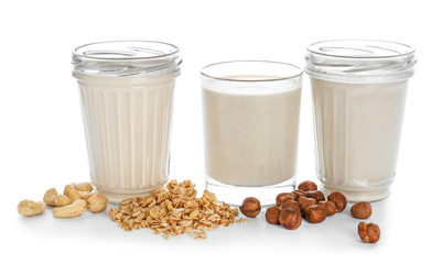 Assortment of tasty vegan milk on white background