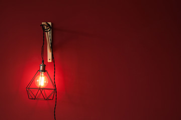 New lamp hanging on color wall