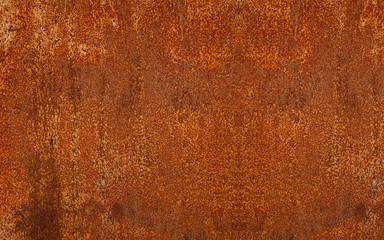 Panoramic rusty yellow-red textured metal surface. The texture of the metal sheet is prone to oxidation and corrosion. Textured background in grunge Style