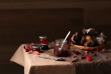 Jars of tasty jams on table