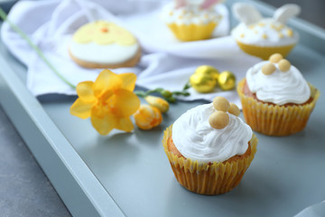 Tasty Easter cupcakes on tray, closeup