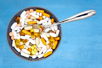  pills in spoon  on blue
