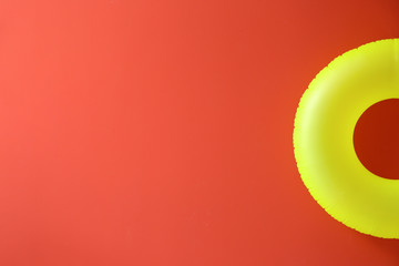 Bright inflatable ring on color background