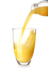 Pouring of tasty orange juice in glass on white background