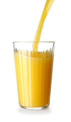 Pouring of tasty orange juice in glass on white background