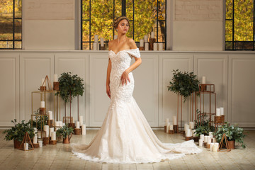 Fototapeta premium Beautiful blonde model posing in luxury wedding dress