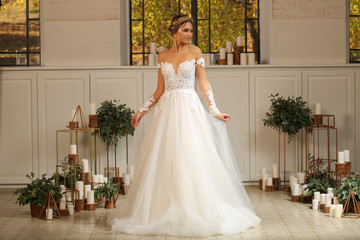 Fototapeta premium Beautiful blonde model posing in luxury wedding dress