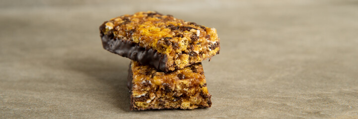 Muesli and cereal bar on marble stone background