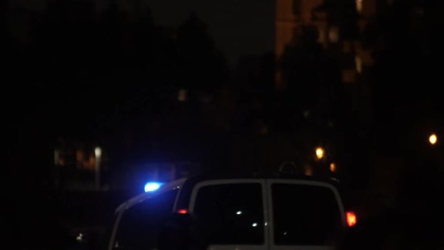 ambulance car with flashlights at wet night road
