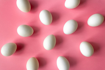 Pattern made of pink eggs on pastel pink background. Minimal concept