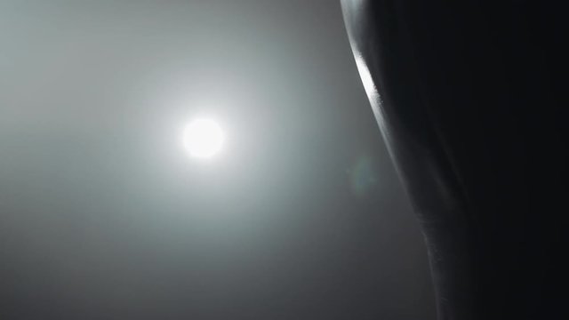 Woman's hand in boxing gloves punching a bag in a boxing club. Close up, slow motion