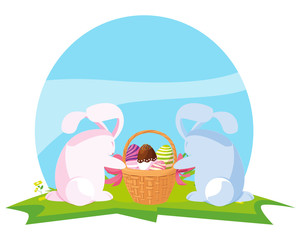 cute rabbits couple with eggs painted in basket