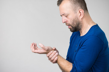 Man feeling pain in wrist