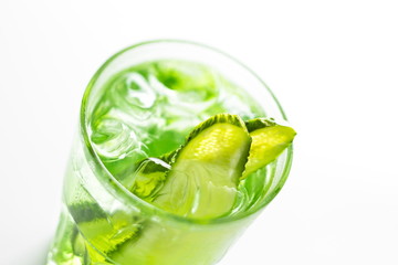Refreshing non-alcoholic summer cocktail with cucumber close up soft focus on a white background