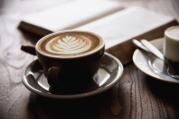 Relax Asian man drink coffee and read book in a modern style coffee shop - people with coffee cup easy lifestyle concept