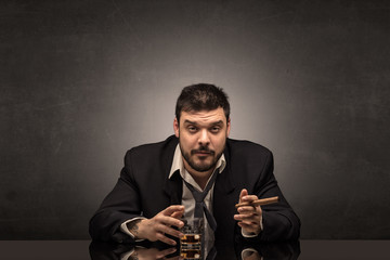 Young drunk man at his office with free dark copyspace