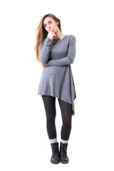 Sad pensive stylish young woman looking up thoughtfully. Full body isolated on white background. 