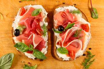 bread slice with ham, cheese and basil