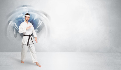 Obraz premium Young businessman in suit fighting with empty wall background 