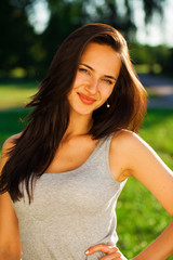 Young brunette woman in summer park