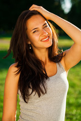 Young brunette woman in summer park