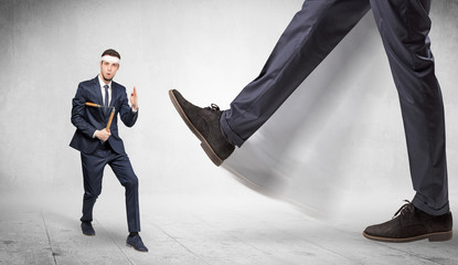 Big foot trample young suited karate man
