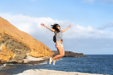 Pretty tourist brunette girl having fun outdoor near sea.
