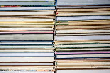 stack of books in a multi-colored cover, close-up