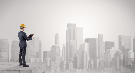 Architect standing on maze and looking at a future plan
