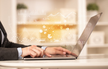 Business woman in homey environment using laptop with financial report concept
