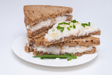 Sandwich with rye brown bread with seeds, fish, green onion. Healthy and tasty snack.