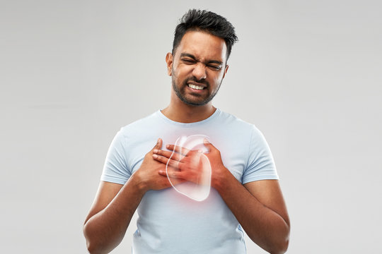 People, Healthcare And Health Problem Concept - Unhappy Man Having Heart Attack Or Heartache Over Grey Background