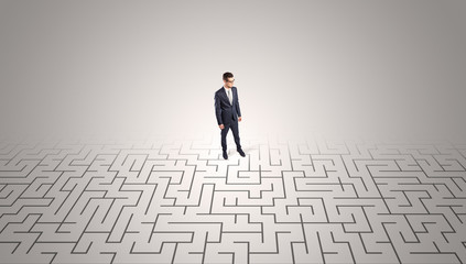 Elegant businessman looking for a solution in a middle of a maze


