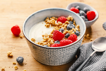 Yogurt with berries and granola in bowl