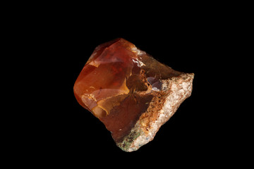 macro stone Carnelian mineral on a black background