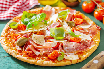 Appetizing italian pizza with prosciutto