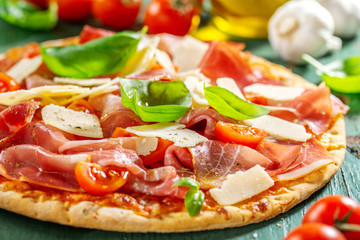 Appetizing italian pizza with prosciutto