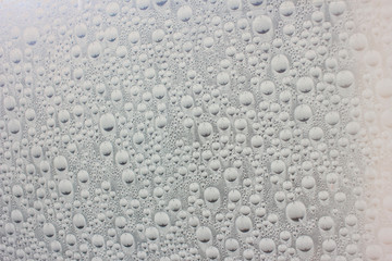 Big drops of water on the glass. Wet surface. Liquid.