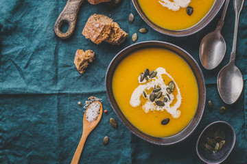 Autumn pumpkin creamy soup in bowls
