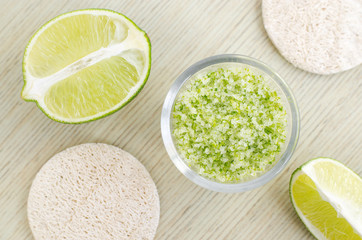 Homemade lime scrub with lime zest and juice, sea salt and olive oil. DIY beauty treatments and spa recipe. Top view, copy space.