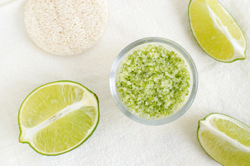 Homemade lime scrub with lime zest and juice, sea salt and olive oil. DIY beauty treatments and spa recipe. Top view, copy space.